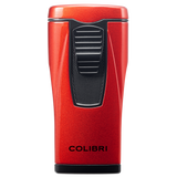 A metallic red Colibri Monaco lighter with a black ignition button and textured grip features triple-jet flames. Displayed upright against a white background, it shows the brand “Colibri, Est. 1928” in black near the base.